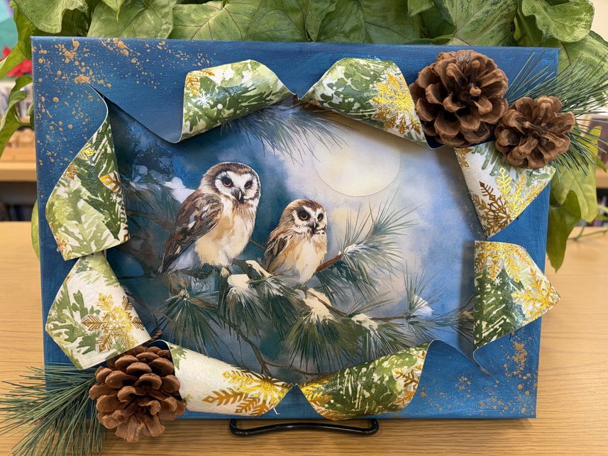 Owl busted canvas craft setting in front of a plant